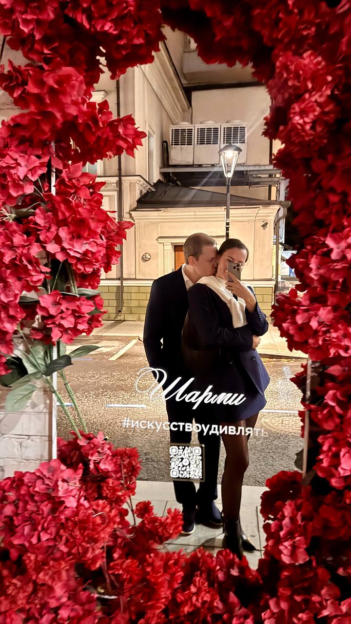 Together in a mirror framed with red flowers