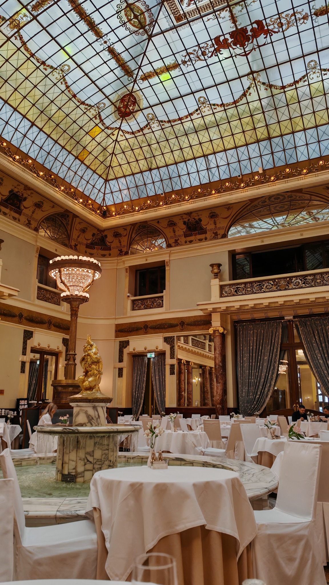 A dining room under a stained-glass ceiling